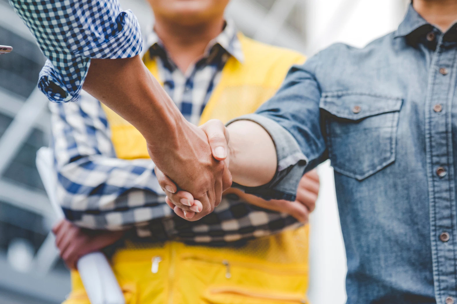 Partnership handshake between engineer and construction lead